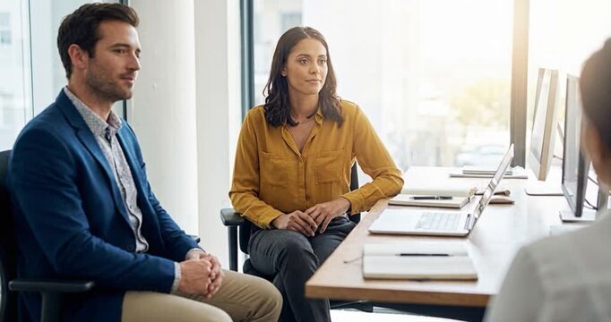 Business professionals in modern office environment discussing project strategy