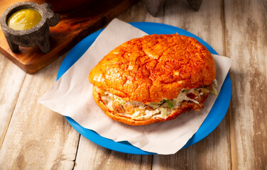 Pambazos. Mexican sandwich marinated in red sauce and roasted on a comal traditionally stuffed with potatoes and chorizo, a classic of Mexico City street food.