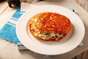 Pambazos. Mexican sandwich marinated in red sauce and roasted on a comal traditionally stuffed with potatoes and chorizo, a classic of Mexico City street food.