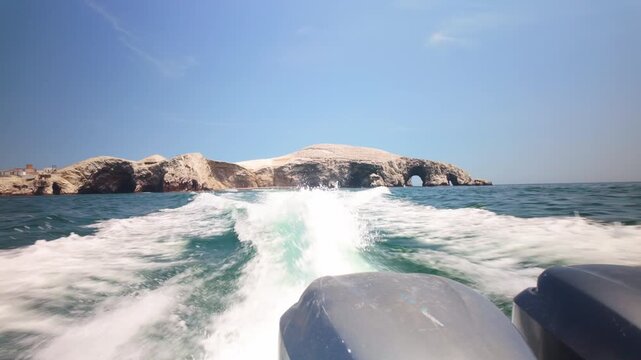 Speed boat leaving ballestas islands in peru