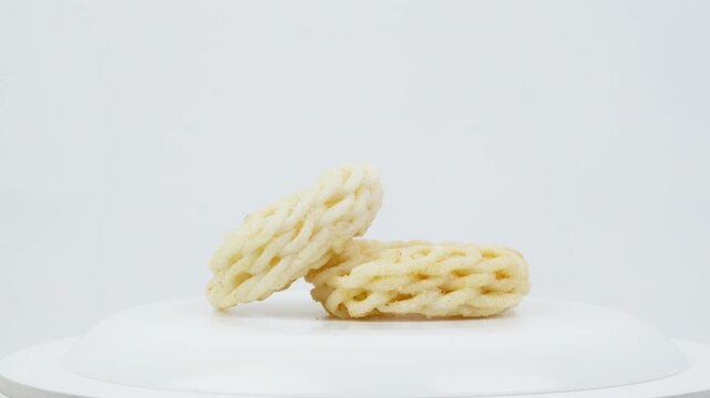 Traditional Asian Crackers Rotating on White Background