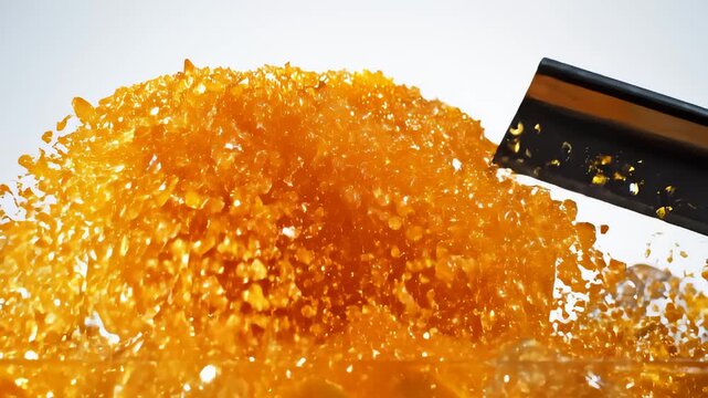 Cutting Block of Orange Jelly Dessert With Cleaver, Crumbles Exploding