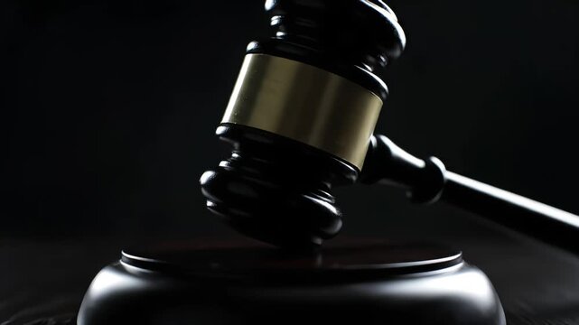 A wooden judge's gavel rests on a sound block under dramatic lighting, symbolizing authority, law, and the finality of a court's decision