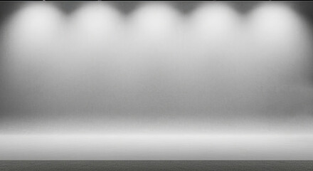 Empty white studio with spotlights on a blank wall.