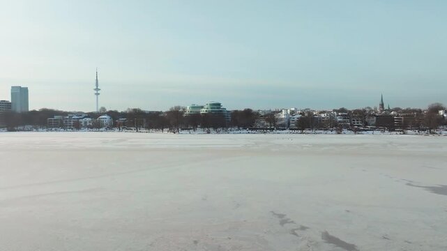 Aerial view of the wintery, frozen Outer Alster in Hamburg covered with heavy snow