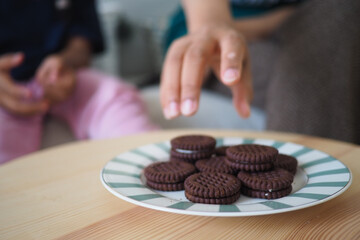 Children enjoy cookies during a gathering at home