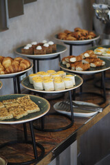 Buffet display of various baked goods and desserts in a cafe