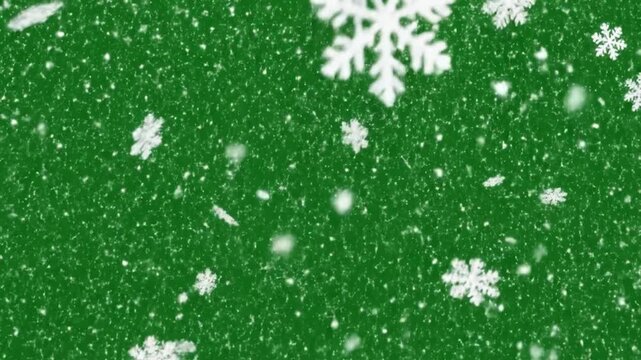 Large and small white snowflakes and blurry specks falling against a vibrant green background
