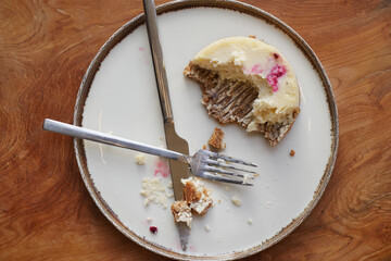 Dessert on a plate with fork and knife after eating