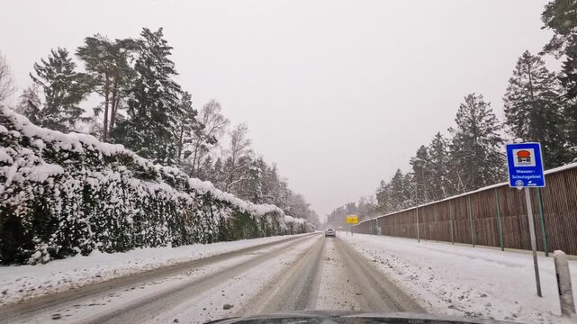 Footage of a wintery car drive on snow-covered roads in Hamburg and the surrounding area