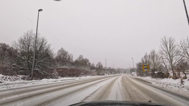 Footage of a wintery car drive on snow-covered roads in Hamburg and the surrounding area
