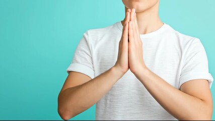 A calm expression of gratitude with hands in a prayer position.