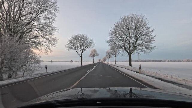 Footage of a wintery car drive on snow-covered roads in Hamburg and the surrounding area