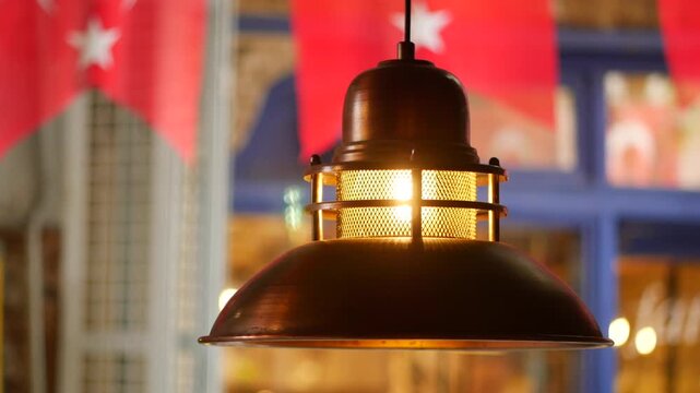 Light fixture shines above tables in a restaurant setting