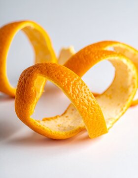 Vibrant Orange Peel Swirls on White Background - A Citrus Delight.