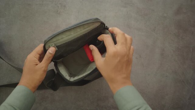 Opening a camera bag and checking the lens inside