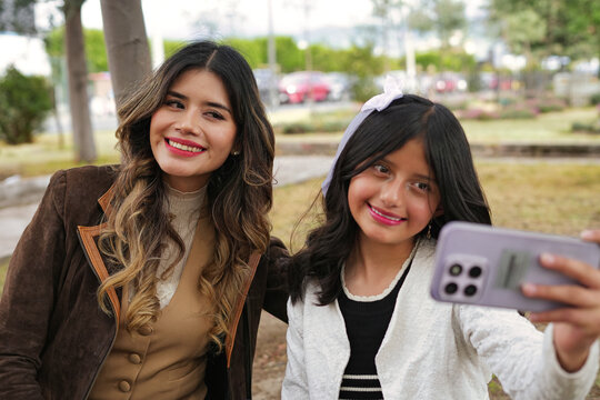 Mother and daugther taking selfie bonding outdoors