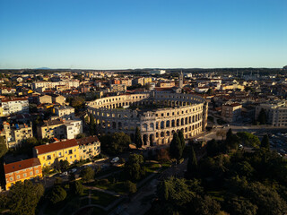 Obraz premium Aerial view of the ancient Roman Pula Arena at sunset, historic amphitheater with long shadows and golden evening light, Istria, Croatia.