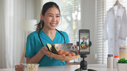 Asia woman people anti aging expert modern health care vlogger live advice talk selfie video mobile phone camera. Online diet food weight loss HDL meal plan recipe digital virtual asian coach filming.