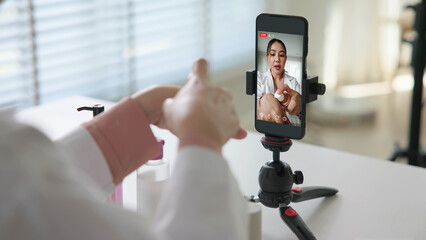 Asia woman people anti aging expert modern health vlogger live advice talk selfie video mobile phone camera. Online digital seller asian small SME store shop owner side hustle filming sell skin care.