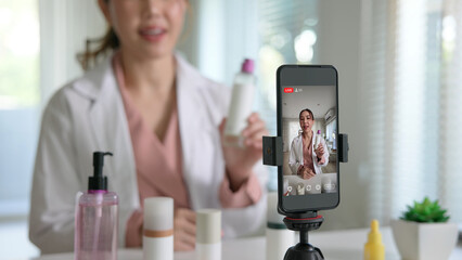 Asia woman people anti aging expert modern health vlogger live advice talk selfie video mobile phone camera. Online digital seller asian small SME store shop owner side hustle filming sell skin care.