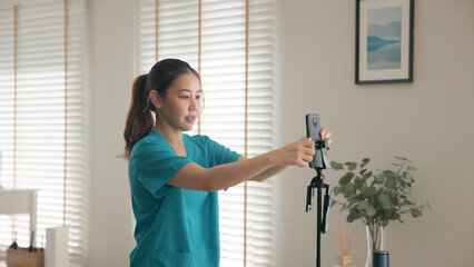 Young adult woman asia Gen Z people anti aging expert modern nurse live talk prepare video selfie camera on mobile phone app mental health care Online side hustle digital virtual asian vlogger filming