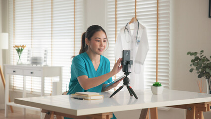 Young adult woman asia Gen Z people anti aging expert modern nurse live talk prepare video selfie camera on mobile phone app mental health care Online side hustle digital virtual asian vlogger filming