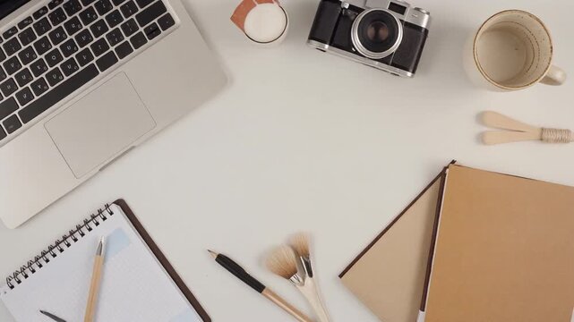 Minimalist Home Office Desk with Side Hustle Tools. Home Finance & Side Hustles (gig economy). A minimalist organized home office desk featuring a laptop a planner a ceramic mug and craft tools .
