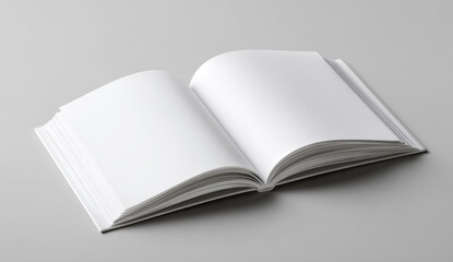 Fototapeta premium Open blank hardcover book with smooth white pages lying on a gray surface