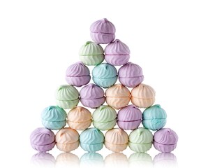Pastel-colored, swirled treats stacked into a pyramid against a white backdrop