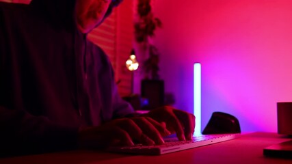 Closeup hand cyber crime. Senior man hacker hacking computer. anonymous hacker wearing black hoodie in dark room. online scam and cyber security threat.