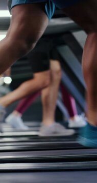 Shoes, fitness and treadmill with group at gym, motion blur or speed training at running class. People, machine and legs with equipment, cardio workout and exercise with challenge at wellness club