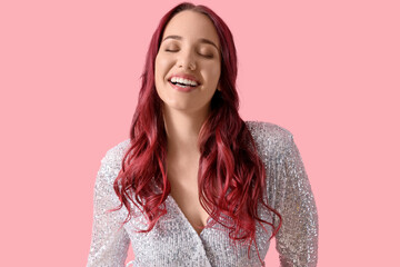 Fototapeta premium Beautiful young woman with red hair on pink background
