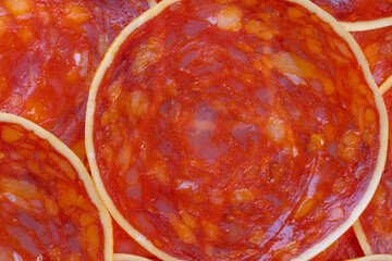 Grocery chorizo closeup for label photography, cured sausage slices showing marbling and color...