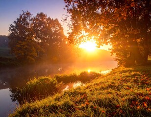 Sunburst at dawn over river, autumn colors highlight trees, grass, and hazy water