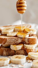 Honey Banana Toast: A close-up slice of artisan toast, with fresh banana slices and drizzled with golden honey
