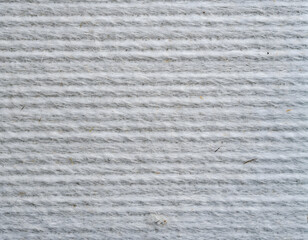 Close-up of textured white wool fabric with horizontal lines