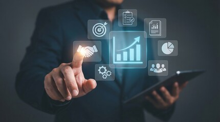 Businessman engaged with digital business strategy icons on a tablet, representing planning, growth, and innovation in a professional setting.