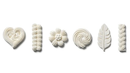 White Piped Icing Decorations Set with Heart, Flower, Leaf, and Swirl Shapes Isolated on White