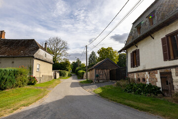 Parfondeval, Vervins, Aisne, Hauts-de-France, Grand-Est, France, August, 28th, 2025, Idyllic countryside route with charming homes, Peaceful rural lane surrounded by quaint cottages and lush hedges