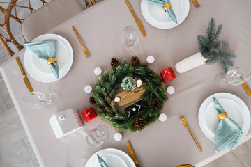 Beautiful festive table setting for Christmas celebration in dining room, top view