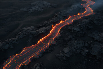 Molten lava river glows in dark volcanic landscape
