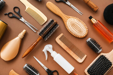 Set of hairdresser's accessories on brown background, closeup
