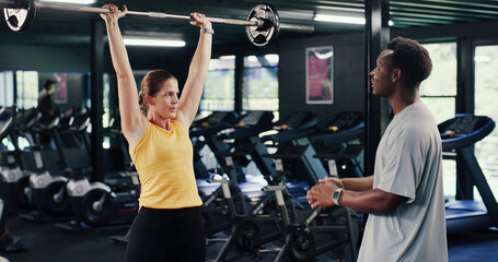 Fitness, instructor or woman in gym with barbell, guidance or help in strength training. Exercise,...
