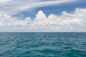 Ocean waves with turquoise water and white clouds
