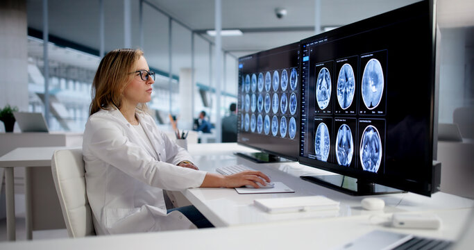 Female Neurology And Radiology Doctor Studies Brain Scan