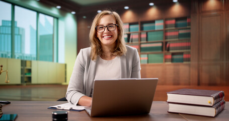 Confident Attorney Posing In Front Of Bookshelf
