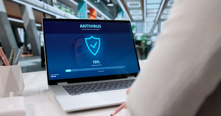 Woman Using Antivirus Software On Laptop