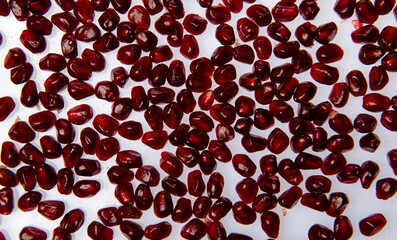 Pomegranate seeds macro texture. Red ruby pomegranate arils closeup pattern. Pomegranate arils...