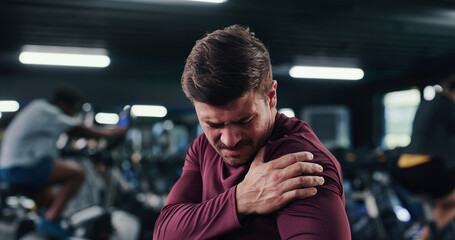 Athlete, man and ache with shoulder pain at gym of fitness injury, muscle fatigue and burnout. Male...